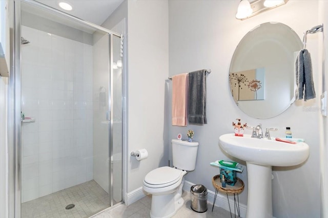 bathroom with tile patterned flooring, sink, toilet, and walk in shower