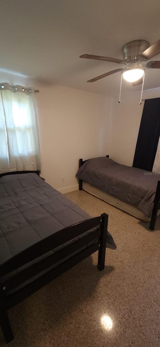 unfurnished bedroom featuring ceiling fan