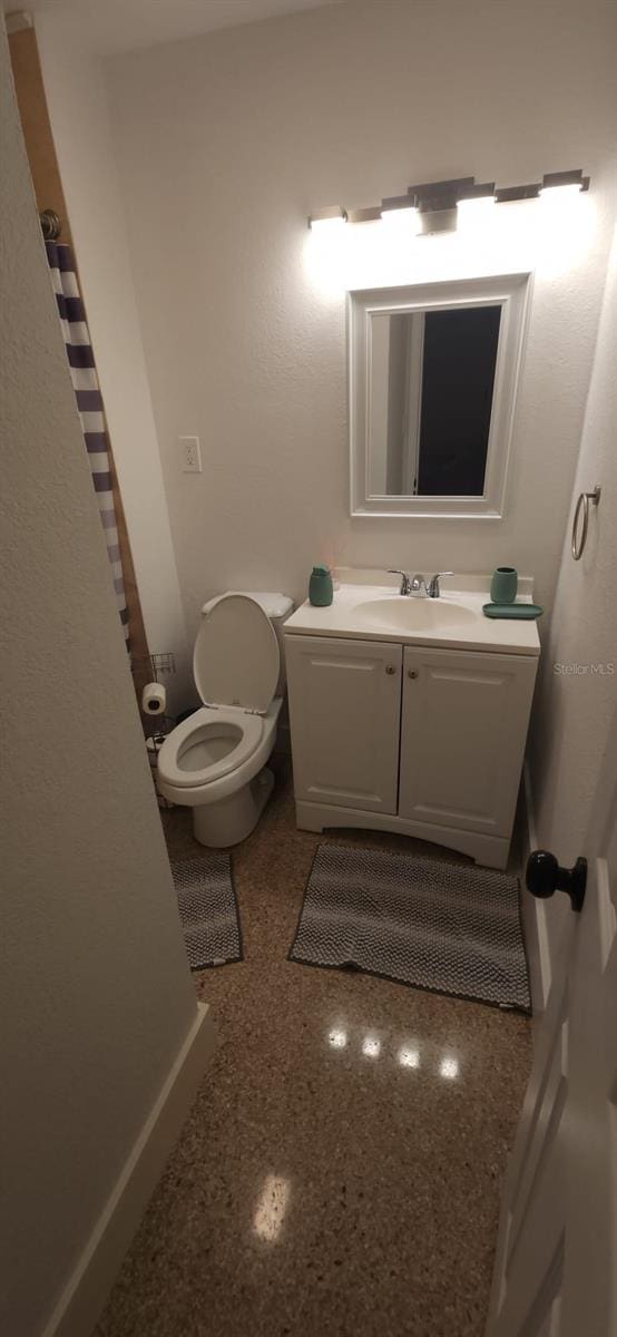 bathroom featuring vanity and toilet