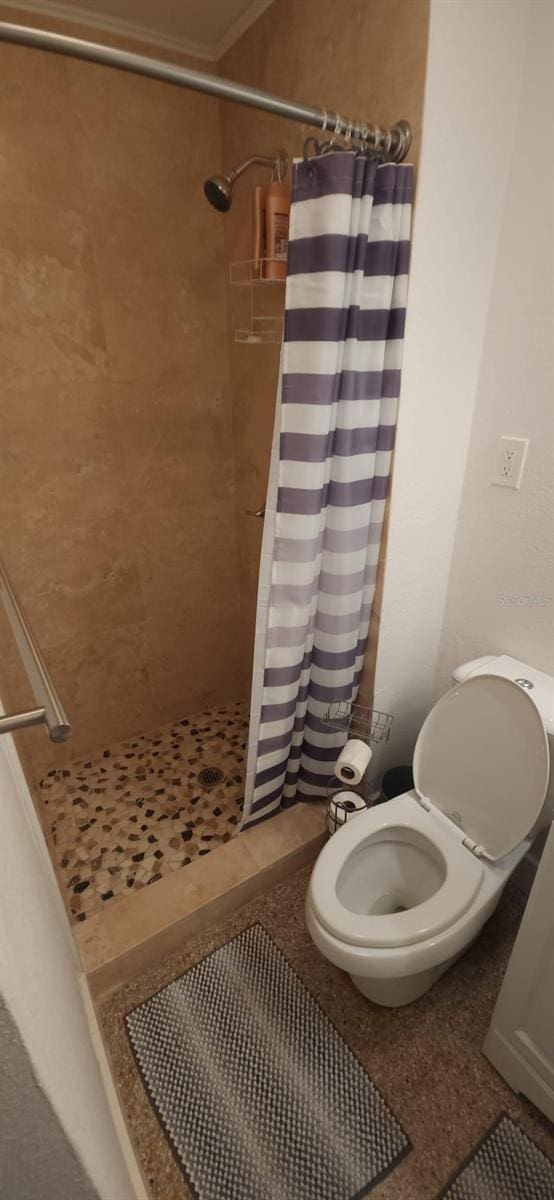 bathroom featuring curtained shower and toilet