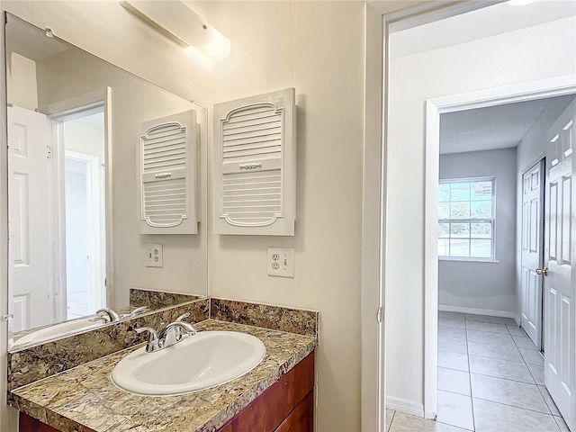 bathroom featuring tile patterned flooring and vanity