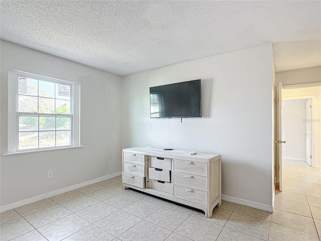 tiled bedroom with a textured ceiling