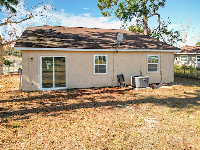 back of house featuring a yard and central AC