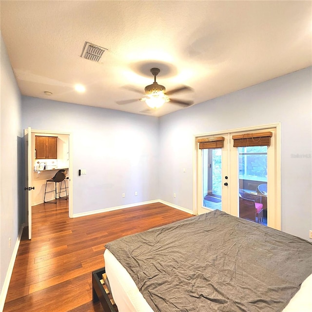 bedroom with ceiling fan, french doors, dark hardwood / wood-style flooring, a textured ceiling, and access to outside