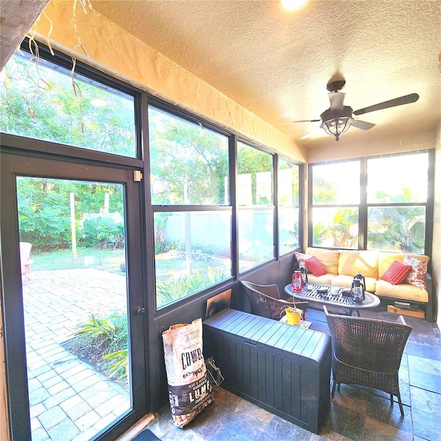 sunroom featuring ceiling fan