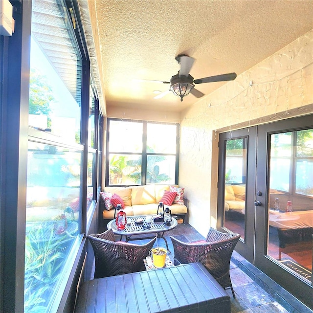 sunroom with a wealth of natural light and ceiling fan