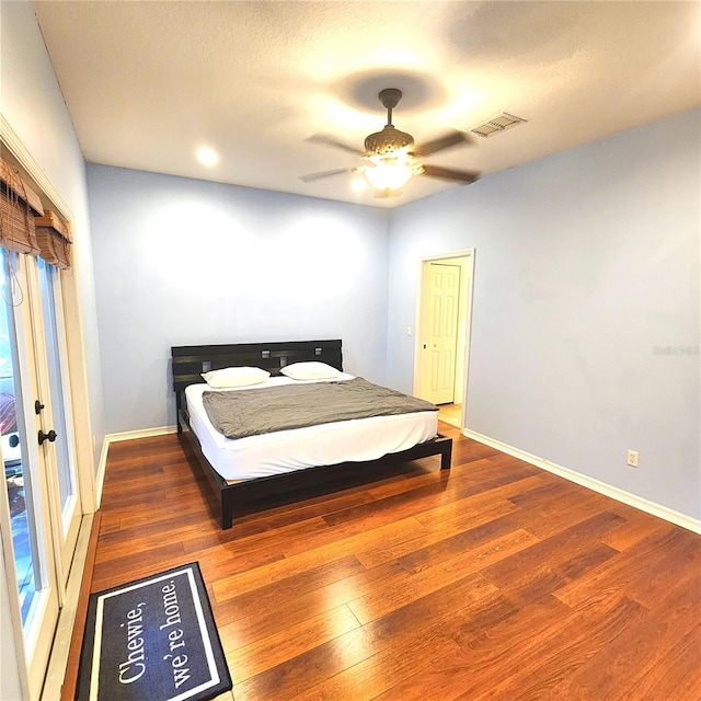 bedroom featuring ceiling fan, wood-type flooring, and a closet