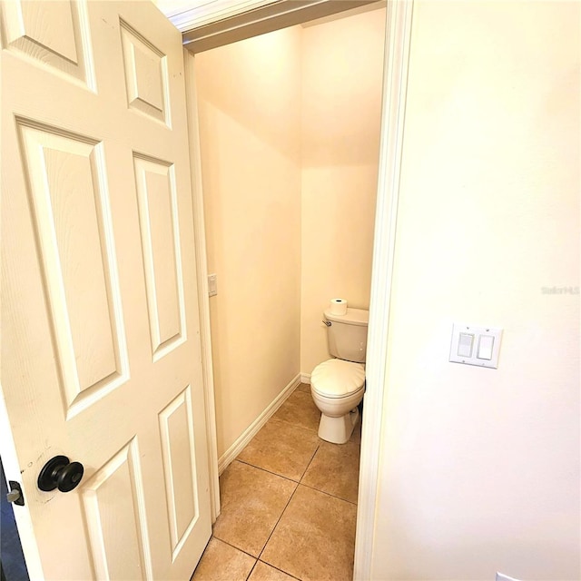 bathroom with toilet and tile patterned floors