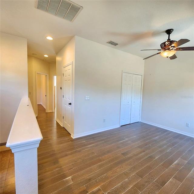 spare room with ceiling fan and dark hardwood / wood-style flooring