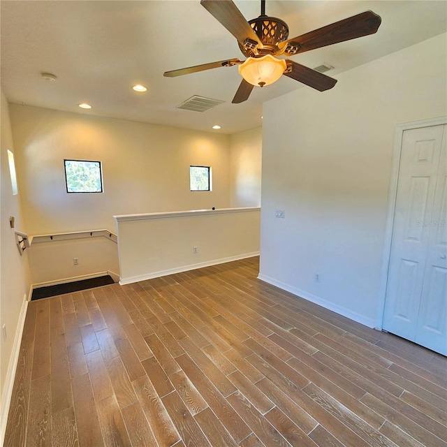 spare room featuring wood-type flooring and ceiling fan