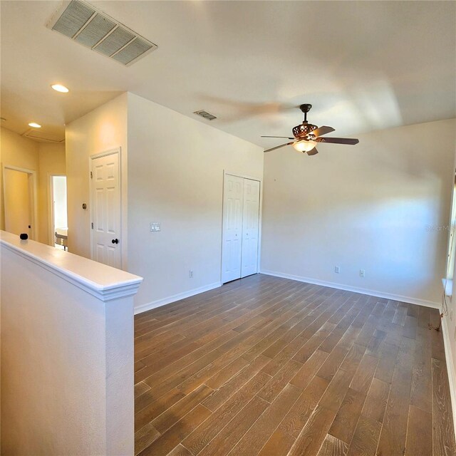 spare room with ceiling fan and dark hardwood / wood-style flooring