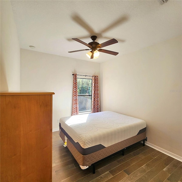 bedroom with ceiling fan and dark hardwood / wood-style flooring