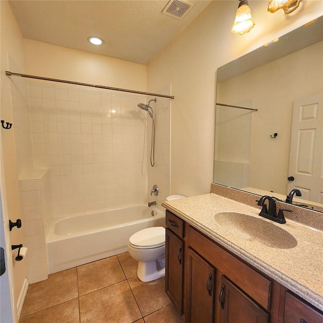 full bathroom with tile patterned flooring, vanity, toilet, and tiled shower / bath