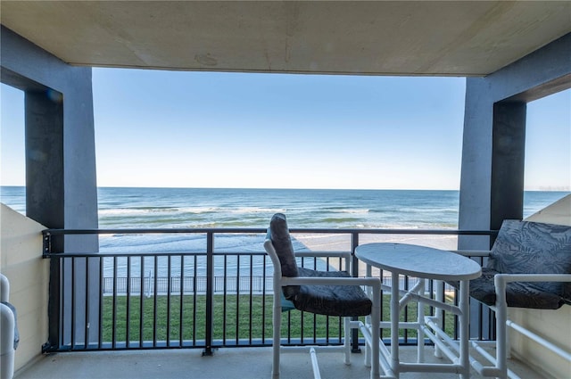 balcony with a beach view and a water view