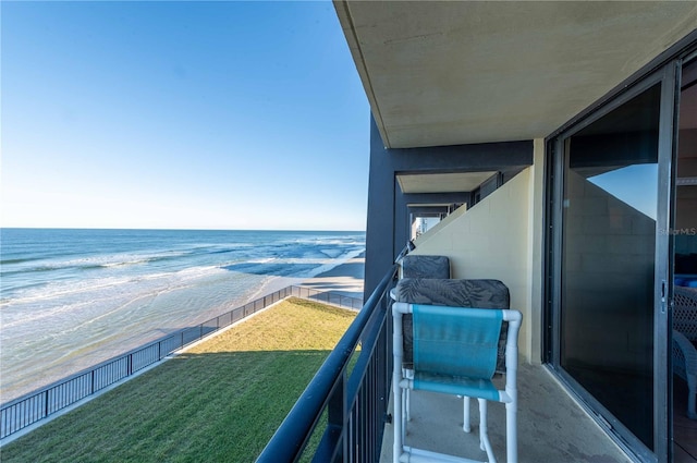 balcony featuring a water view and a beach view