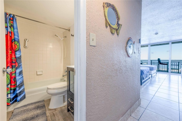 full bathroom with tile patterned flooring, vanity, shower / bath combination with curtain, and toilet