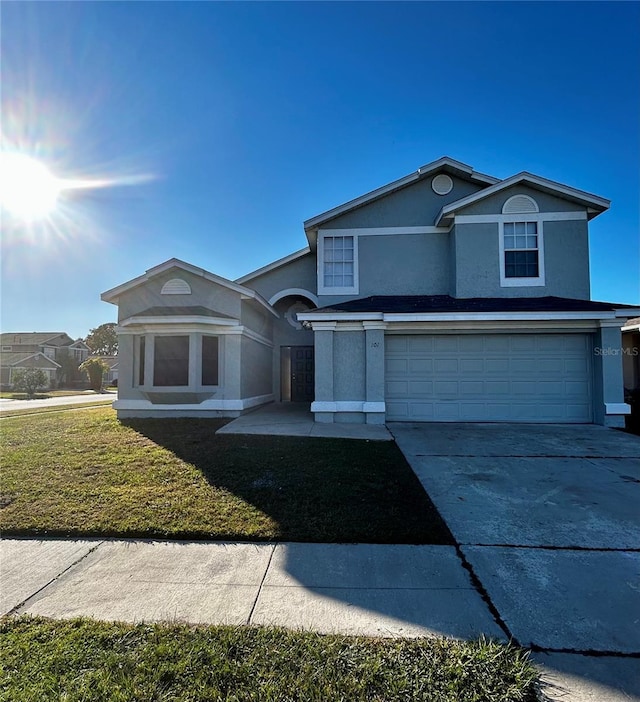 front of property with a garage and a front lawn