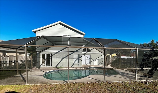 view of swimming pool with a lanai and a patio area