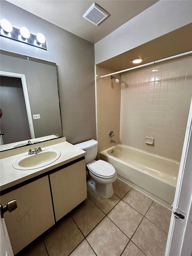 full bathroom with tile patterned flooring, vanity, toilet, and tiled shower / bath combo