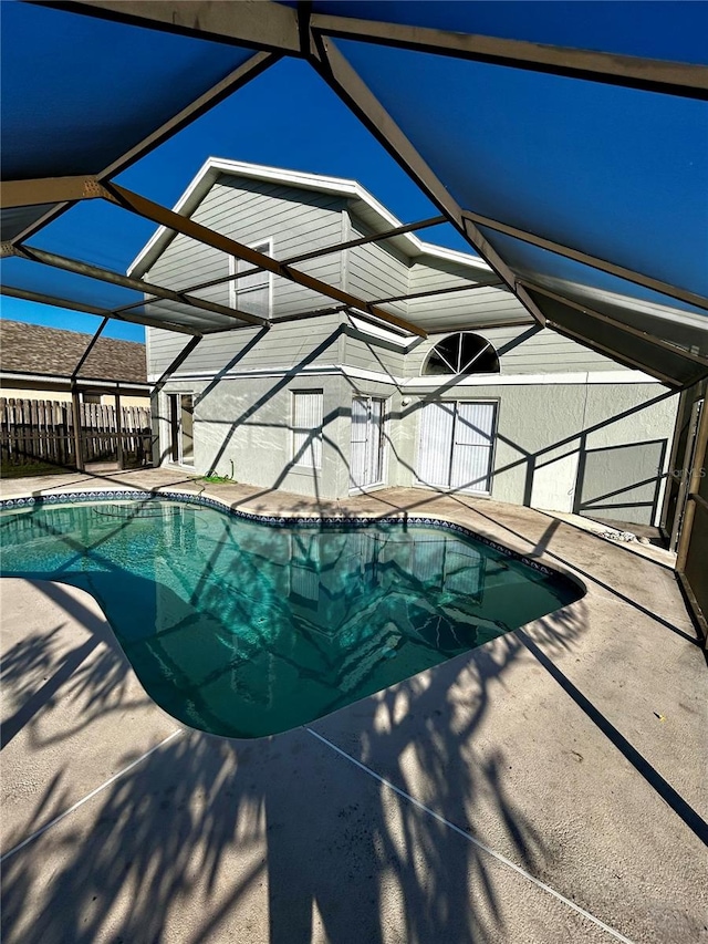 view of pool with a patio and a lanai