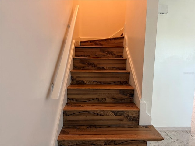 stairs featuring tile patterned flooring