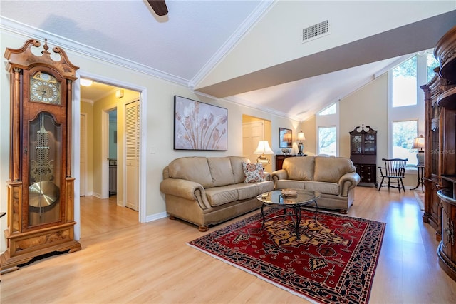 living room with ceiling fan, high vaulted ceiling, light hardwood / wood-style floors, and ornamental molding