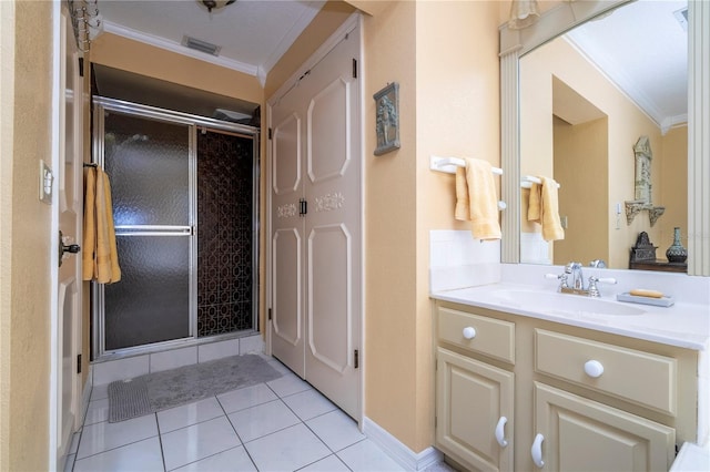 bathroom with tile patterned floors, crown molding, vanity, and a shower with shower door