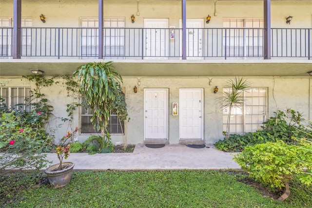 view of exterior entry featuring a balcony