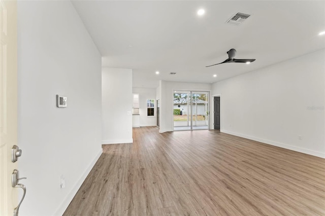 unfurnished living room featuring ceiling fan and light hardwood / wood-style flooring