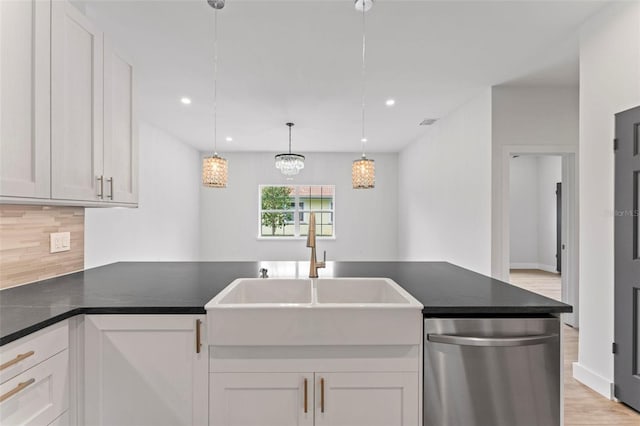 kitchen with dishwasher, sink, backsplash, pendant lighting, and white cabinets