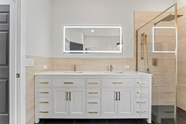 bathroom with tile patterned flooring, vanity, tile walls, and walk in shower