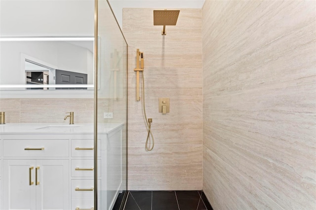 bathroom featuring tile patterned flooring, vanity, and walk in shower