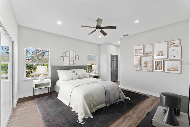 bedroom featuring hardwood / wood-style floors and ceiling fan