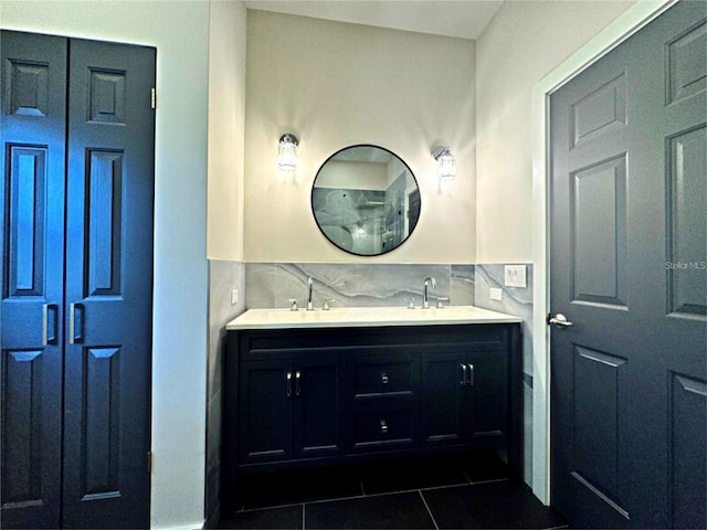 bathroom featuring decorative backsplash, vanity, and tile patterned flooring