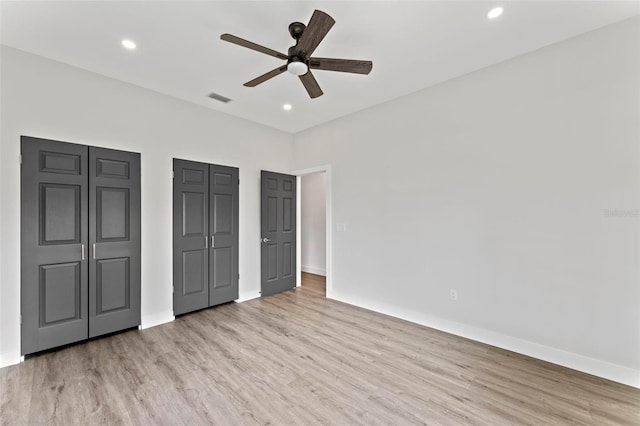 unfurnished bedroom featuring ceiling fan and light wood-type flooring