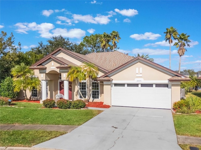 view of front of home featuring a garage and a front lawn