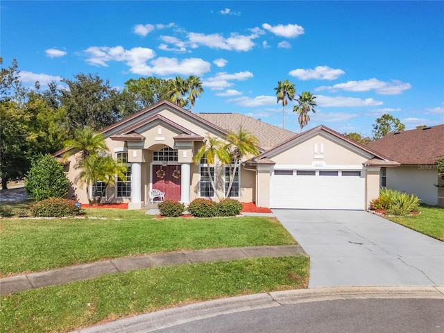 ranch-style home with a garage and a front lawn