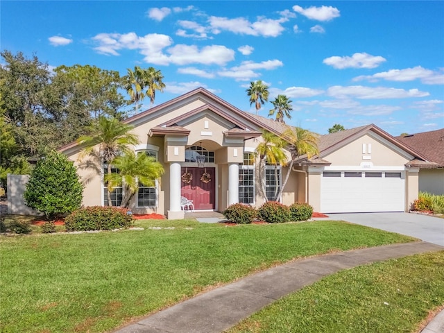 view of front of property with a garage and a front lawn