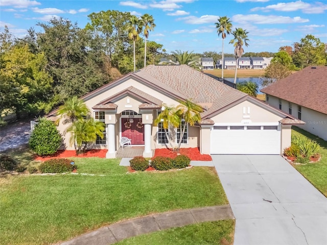 view of front of property featuring a front yard and a garage