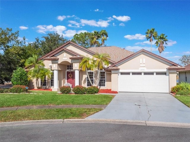 view of front facade with a garage and a front yard