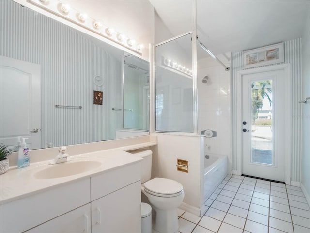 full bathroom with toilet, vanity, tile patterned floors, and tiled shower / bath combo