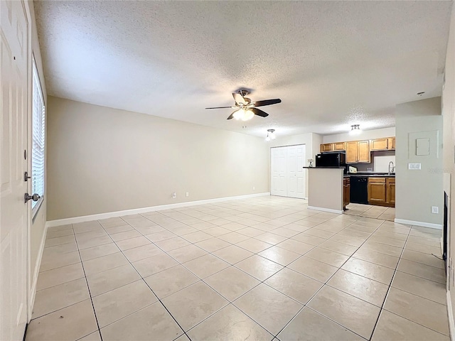 unfurnished living room with ceiling fan, light tile patterned flooring, sink, and a textured ceiling