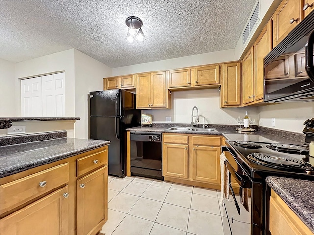 kitchen with black appliances, sink, and a textured ceiling