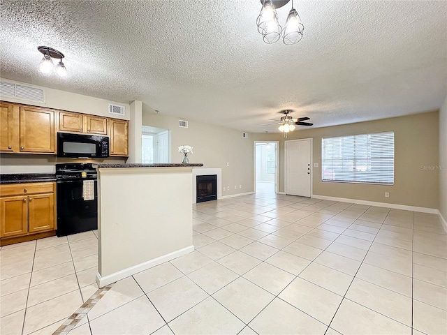 kitchen with light tile patterned floors, ceiling fan with notable chandelier, black appliances, and a textured ceiling