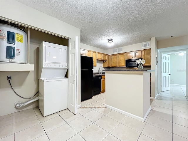 kitchen featuring a textured ceiling, light tile patterned floors, black appliances, and stacked washer / drying machine