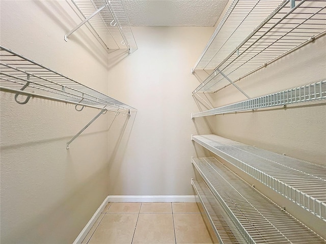 walk in closet featuring tile patterned flooring