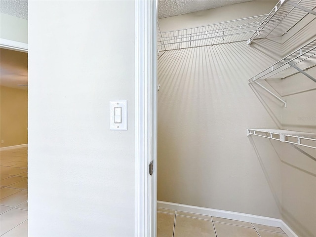 spacious closet with light tile patterned floors