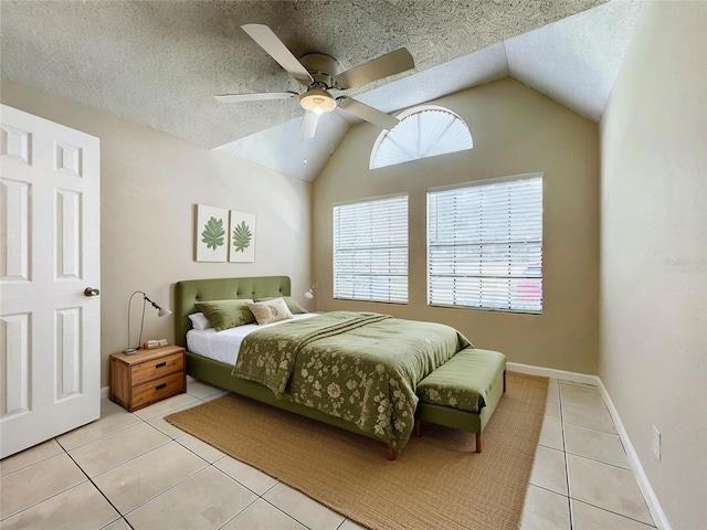 bedroom featuring lofted ceiling, a textured ceiling, light tile patterned flooring, and baseboards