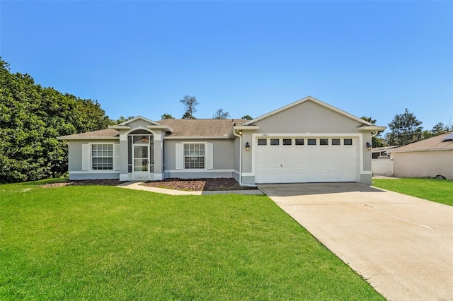 ranch-style house featuring a garage and a front lawn