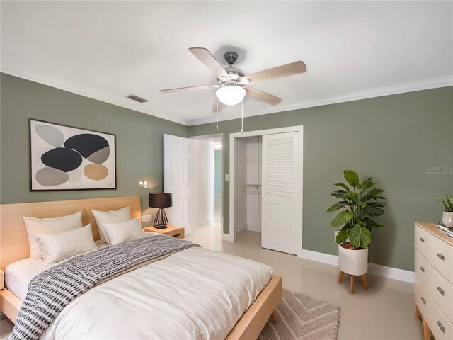 bedroom featuring ceiling fan, a closet, and crown molding